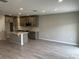 Open-concept kitchen with gray cabinets, stainless steel microwave, subway tile backsplash, and a large island at 5101 Prairie Preserve Run, St Cloud, FL 34772