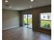 Bright living room with sliding glass doors leading to the backyard and large windows at 5101 Prairie Preserve Run, St Cloud, FL 34772