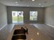 Open-concept living room with sliding glass doors leading to the backyard and plenty of natural light at 5101 Prairie Preserve Run, St Cloud, FL 34772