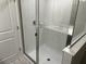Modern bathroom shower with glass doors and white tile surround at 5101 Prairie Preserve Run, St Cloud, FL 34772