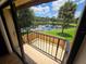 Balcony overlooking a serene pond surrounded by lush greenery and a palm tree at 5288 Cypress Ct # 439, Orlando, FL 32811