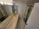 Well-lit bathroom featuring neutral-colored tile, a shower, and a spacious double vanity at 5288 Cypress Ct # 439, Orlando, FL 32811
