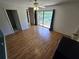 Bright bedroom featuring wood-look flooring, a ceiling fan, and sliding glass doors to balcony at 5288 Cypress Ct # 439, Orlando, FL 32811