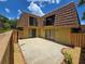 Townhome with patio, fenced yard, and unique roof design, offering a private outdoor space at 5288 Cypress Ct # 439, Orlando, FL 32811