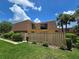 Charming townhome featuring a unique roof, fenced yard, and lush landscaping at 5288 Cypress Ct # 439, Orlando, FL 32811