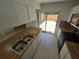 Bright kitchen with double basin sink and sliding glass door to outdoor patio at 5288 Cypress Ct # 439, Orlando, FL 32811