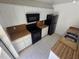 Clean kitchen featuring white cabinets, black appliances, and tile flooring at 5288 Cypress Ct # 439, Orlando, FL 32811