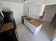 Functional kitchen featuring a double sink, wood countertops, and ample cabinet space at 5288 Cypress Ct # 439, Orlando, FL 32811