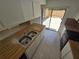 Bright kitchen with double basin sink and sliding glass door to outdoor patio at 5288 Cypress Ct # 439, Orlando, FL 32811