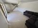 Open living space with tile flooring, a comfortable sofa, and staircase access at 5288 Cypress Ct # 439, Orlando, FL 32811