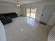 Spacious living room with tiled floors, natural light, and a sliding door to the patio at 5288 Cypress Ct # 439, Orlando, FL 32811