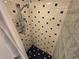 Close-up of a tiled shower area with a glass block partition and a shower curtain at 5288 Cypress Ct # 439, Orlando, FL 32811