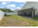 Spacious backyard with a screened-in porch, white fence, and landscaped features at 5365 Rocking Horse Pl, Oviedo, FL 32765