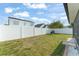 Well-maintained backyard featuring a white fence and lush green lawn at 5365 Rocking Horse Pl, Oviedo, FL 32765