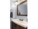 Elegant half bathroom features a wooden vanity, modern fixtures, and a warm neutral color scheme at 5365 Rocking Horse Pl, Oviedo, FL 32765