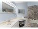 Bathroom with granite countertops, vanity, and soaking tub with stone accents at 5365 Rocking Horse Pl, Oviedo, FL 32765