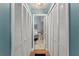 Hallway leading to a bathroom with a vanity and stone accent wall at 5365 Rocking Horse Pl, Oviedo, FL 32765