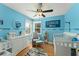 Charming Bedroom with blue walls, two cribs, and a window offering natural light at 5365 Rocking Horse Pl, Oviedo, FL 32765