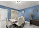 Stylish dining room featuring a marble dining table, seating for six, with a view to the rear yard at 5365 Rocking Horse Pl, Oviedo, FL 32765