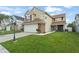 Beautiful two-story home with green lawn and stone accents on the attached two car garage at 5365 Rocking Horse Pl, Oviedo, FL 32765