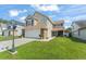 Inviting two-story home with a well-manicured lawn, charming stone accents, and a two-car garage at 5365 Rocking Horse Pl, Oviedo, FL 32765