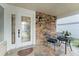 Charming front porch with stone accents, seating area, and decorative glass door at 5365 Rocking Horse Pl, Oviedo, FL 32765