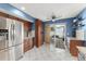 Bright kitchen with stainless steel refrigerator, dark wood cabinets, and access to an outdoor space at 5365 Rocking Horse Pl, Oviedo, FL 32765