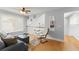 Bright living room with hardwood floors, cozy seating, and a ceiling fan for added comfort at 5365 Rocking Horse Pl, Oviedo, FL 32765