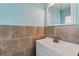 Powder room featuring tile accents, vanity, sink and fixtures at 540 W Columbia St, Lake Alfred, FL 33850