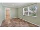 Bedroom with natural light, neutral walls, and hard surface floors is awaiting your personal touch at 540 W Columbia St, Lake Alfred, FL 33850