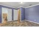 Bedroom with tile floors, doors and access to bathroom with toilet at 540 W Columbia St, Lake Alfred, FL 33850