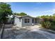 Charming single-story home with a concrete driveway, grey exterior, and a screened-in porch perfect for relaxing at 540 W Columbia St, Lake Alfred, FL 33850
