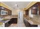 Galley kitchen featuring granite countertops, stainless steel appliances and tile floors at 540 W Columbia St, Lake Alfred, FL 33850