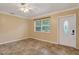 Bright living room with tile flooring, a ceiling fan, and a large window offering plenty of natural light at 540 W Columbia St, Lake Alfred, FL 33850
