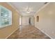 Open living room with tile floors, crown molding, natural light, and ceiling fan at 540 W Columbia St, Lake Alfred, FL 33850