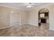 Open-concept living area featuring tile floors, an archway, and seamless flow into the kitchen for modern living at 540 W Columbia St, Lake Alfred, FL 33850