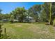 Large backyard with lush green grass and a charming view of the rear of the house at 5420 Lido St, Orlando, FL 32807