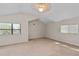 Spacious bedroom with carpeted floors, vaulted ceilings, and dual windows for ample natural light at 5420 Lido St, Orlando, FL 32807
