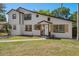 Charming two-story home featuring neutral paint, a well-maintained lawn and inviting front porch at 5420 Lido St, Orlando, FL 32807