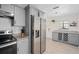 Updated kitchen showcasing stainless steel refrigerator, granite counters, white subway tile and wine rack storage at 5420 Lido St, Orlando, FL 32807
