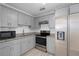 Modern kitchen featuring gray cabinets, granite countertops, stainless steel appliances and white subway tile backsplash at 5420 Lido St, Orlando, FL 32807