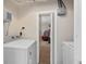 Functional laundry room with a washer and dryer, with an adjacent room visible in the background at 5420 Lido St, Orlando, FL 32807