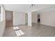 Open living area with tile floors, bright lighting, and direct access to kitchen and stairs at 5420 Lido St, Orlando, FL 32807