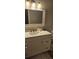 Bathroom vanity with a rectangular mirror and overhead lights at 6026 Canyon De Chelley Ct, Orlando, FL 32810