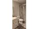 Bathroom featuring a tiled shower, toilet, and vanity at 6026 Canyon De Chelley Ct, Orlando, FL 32810
