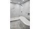 Modern bathroom featuring marble tile, frameless shower, and sleek soaking tub at 6026 Canyon De Chelley Ct, Orlando, FL 32810