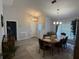 Dining room with modern flooring and large windows providing ample natural light at 6026 Canyon De Chelley Ct, Orlando, FL 32810