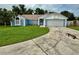 Charming single-story home with well-maintained lawn, attached two-car garage, and blue and white color scheme at 6026 Canyon De Chelley Ct, Orlando, FL 32810