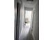 Hallway showcasing modern flooring and neutral paint, leading to a bedroom at 6026 Canyon De Chelley Ct, Orlando, FL 32810