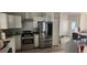 Kitchen with stainless steel appliances and view into the adjacent dining room at 6026 Canyon De Chelley Ct, Orlando, FL 32810